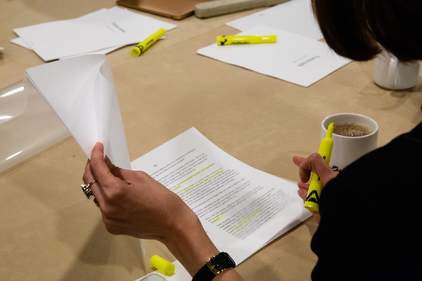 Photo of a team member highlighting a printed transcript.