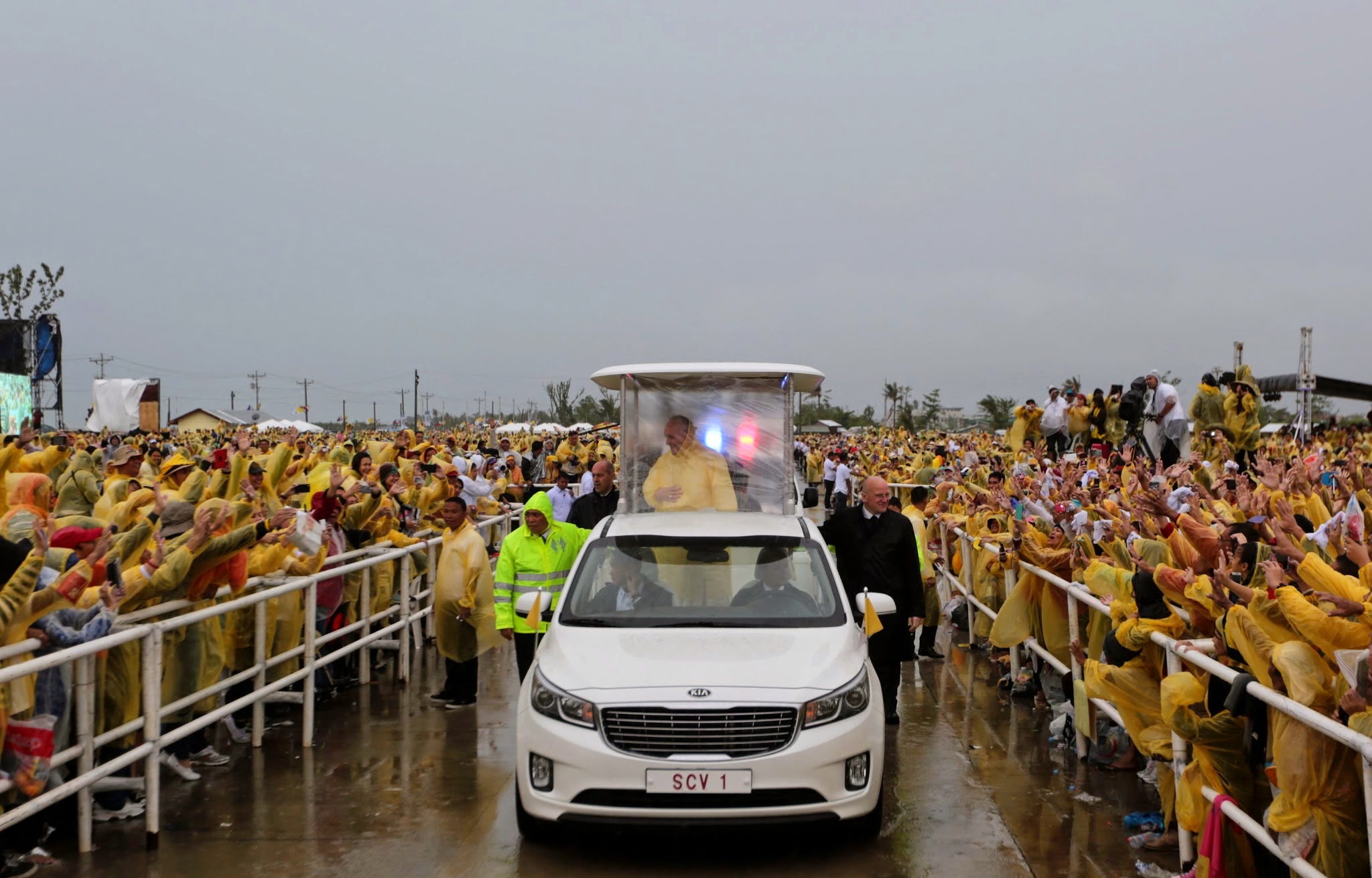 A photo of the popemobile, a car with a raised center section for the pope to be visible, but still protected